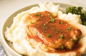 Côtelettes de porc au four servi avec pommes de terres rôties et laitue